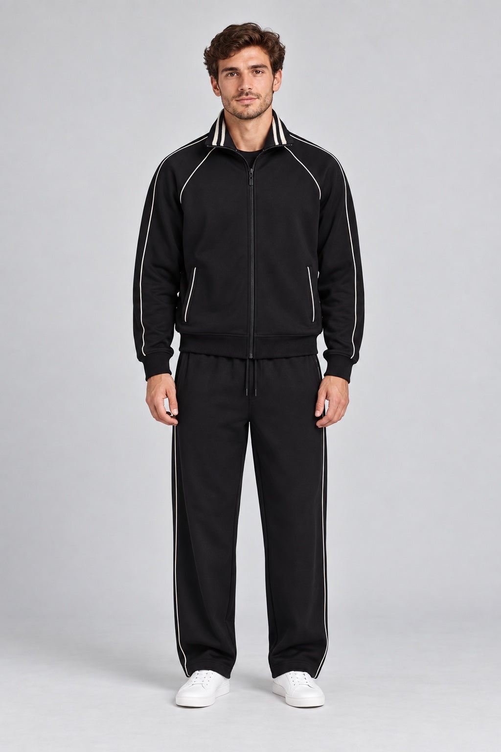 Modello indossa tuta sportiva nera Follower SRL con zip intera, colletto alto e dettagli a righe bianche a contrasto
