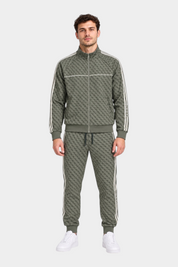 Modello indossa tuta Follower SRL verde con logo GUESS all-over, zip integrale e bande laterali a contrasto